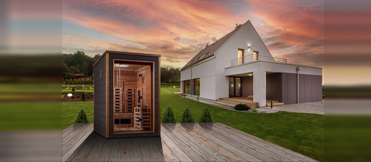 An outdoor sauna glowing warmly at sunset